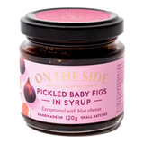 The Artisan Cheese Room jar of pickled baby figs in syrup with a pink label, perfect for pairing with blue cheese.