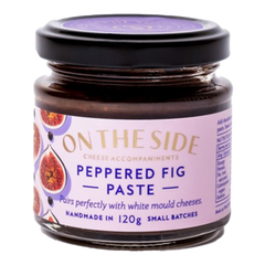 The Artisan Cheese Room Peppered Fig Paste in a small glass jar with a purple label featuring fig illustrations.