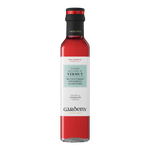 The Artisan Cheese Room Gardeny Vermut Vinegar in a clear glass bottle with a red liquid and black cap.